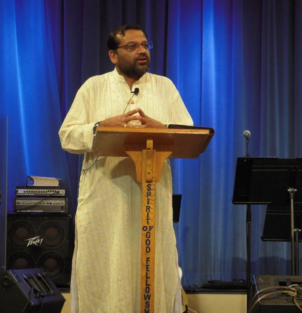 Dr. J.N. Manokaran preaching at a pulpit