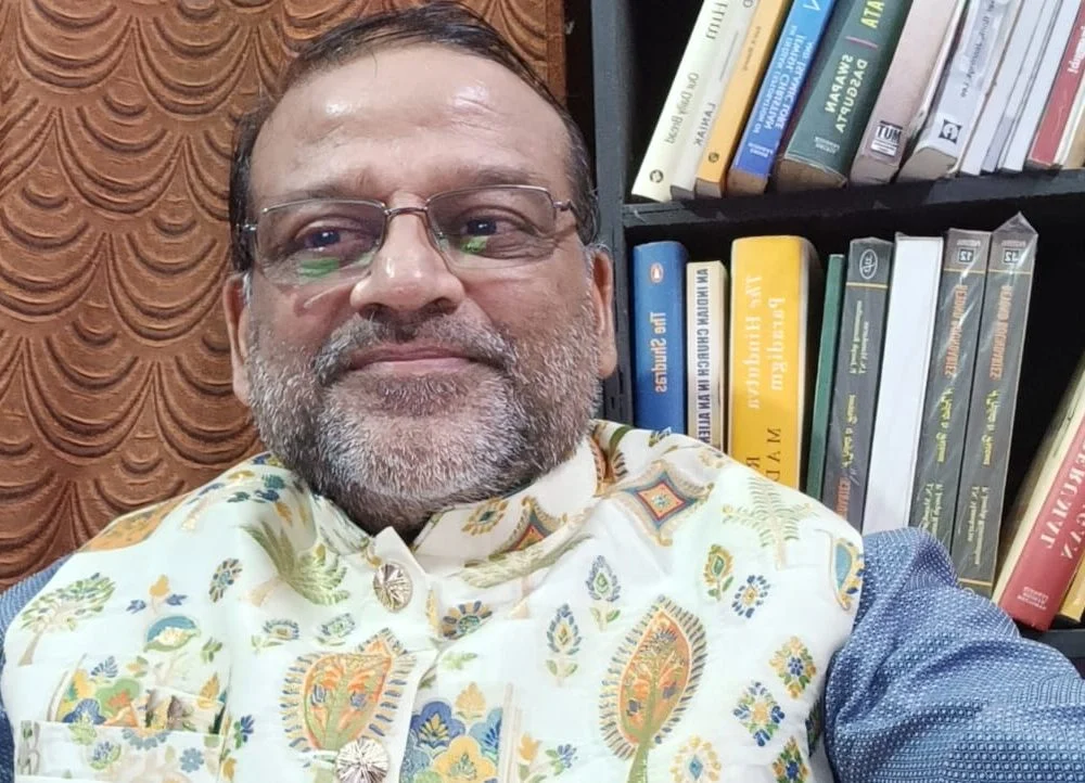Dr. J.N. Manokaran in his study in front of a bookshelf